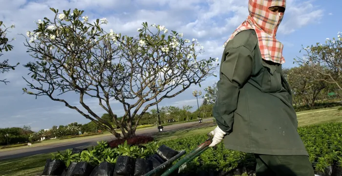 Bangkok city gardeners at work in the Rama IX Park, the largest park in the city