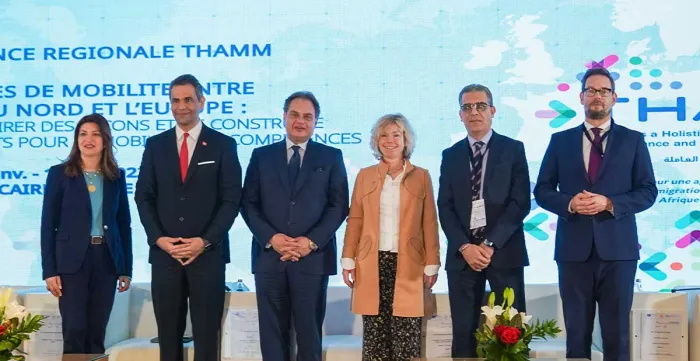 A diverse group of individuals standing together on a stage representing the opening ceremony speakers.