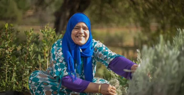 A woman in Morocco working in the green field, showcasing the organization's efforts in advancing gender equality, promoting women's economic empowerment, and combating violence against women.
