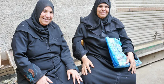 Two women sit outside in Bab el Foutouh District. Cairo, Egypt.