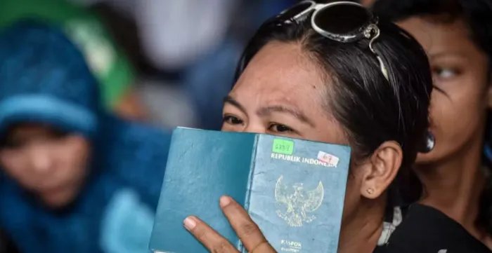 A face of a women covered with a passport
