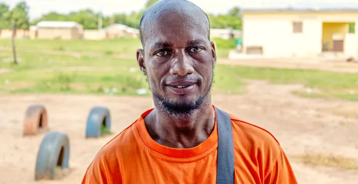 Diallo Koundja, an asylum seeker from Burkina Faso in northern Côte d'Ivoire, stands proudly facing the camera