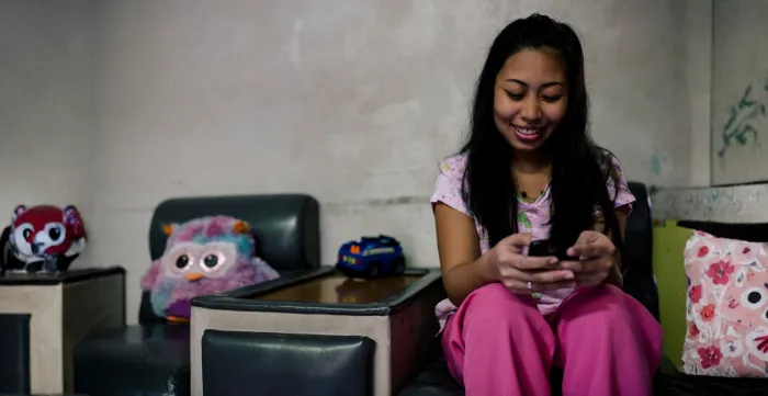 Mobile phones help domestic workers stay connected with friends and family.