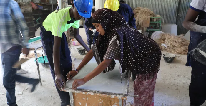 a young woman and a man attending training on woodwork in Ethiopia.