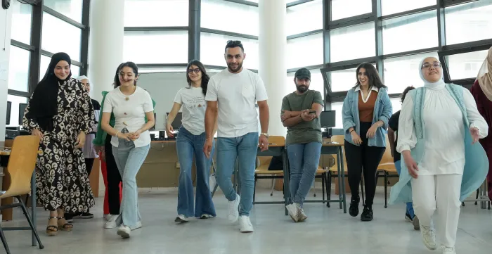 Men and women posing at event in Jordan