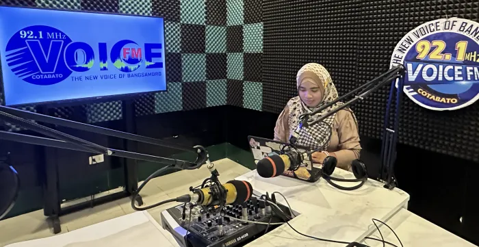 a woman wearing hijab in a radio station