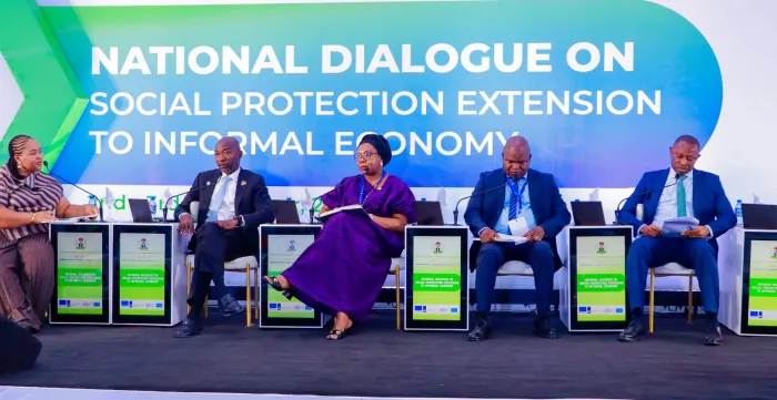 A group of high-level stakeholders seated on stage at the National Dialogue event
