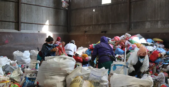 Waste segregation workers at a transfer site.