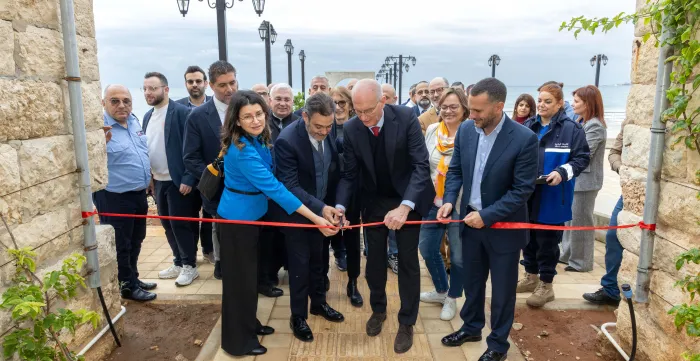 Cutting ribbon for inaugartion with a group