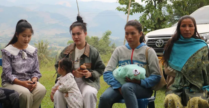 Women and babies sit together 