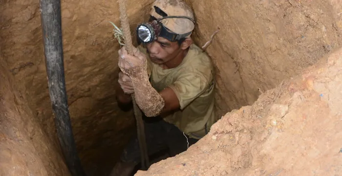 man going down a mine hole