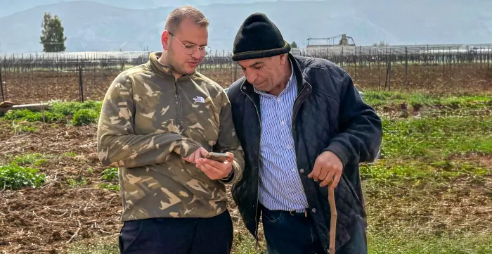 Tarek Daoud hosts neighboring farmers visiting his greenhouse to observe the sensor-based system and discuss improved irrigation and crop management practices. Bekaa, Lebanon. March, 2025