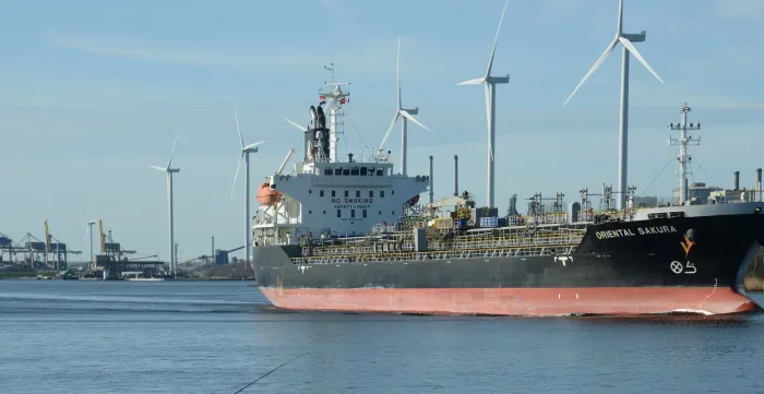 Chemical-oil products tanker passing by wind turbines