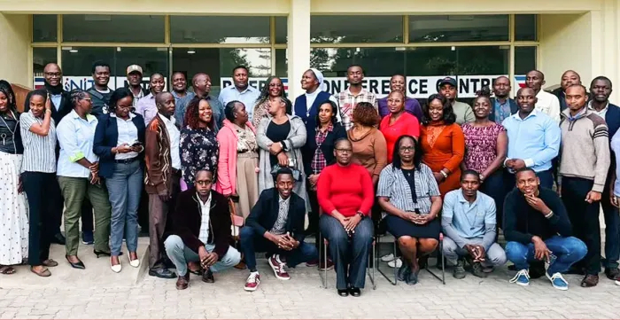 A large group of stakeholders poses for a photo outside a conference facility in Kenya after a forum to validate new occupational curricula for the tourism and fodder sectors.