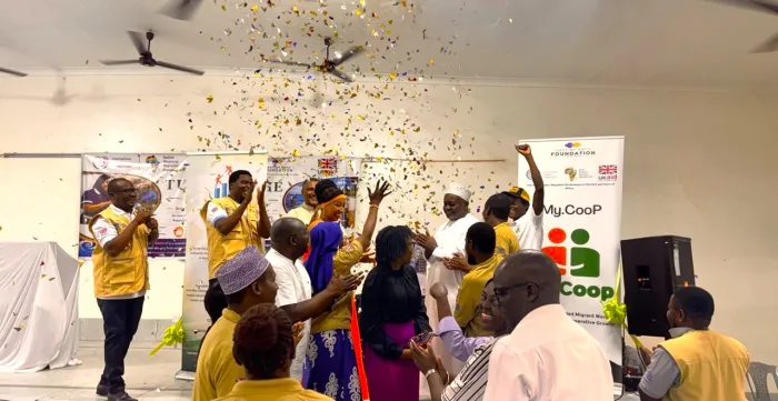 Participants celebrate the launch of a SACCO with confetti, clapping and cheering during an event in Mombasa