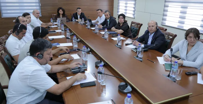 Participants seated around a conference table during a seminar