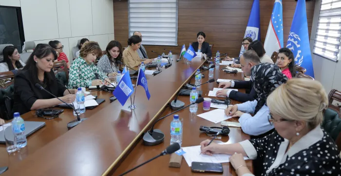 Participants seated around a long conference table
