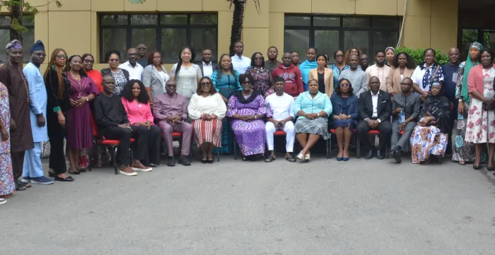 Large group of participants, facilitators and officials posing for a photograph outside the training venue in Abuja following a TRANSFORM capacity-building session.