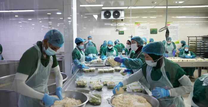 Workers at a food-processing factory in Irbid, Jordan, during an ILO visit to conduct a legal awareness session, 23 August 2026.