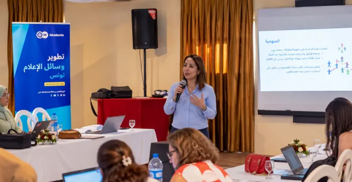 Ahlem Amri of the ILO speaks to journalists during a workshop on sustainable tourism in Monastir, Tunisia.