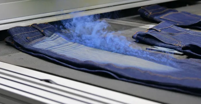 Denim jeans undergoing a finishing process at Eroğlu Manufacturing Studio in Ismailia, Egypt.