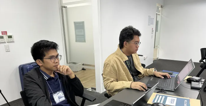 Two male participants using the Building Information Modeling on their computers.