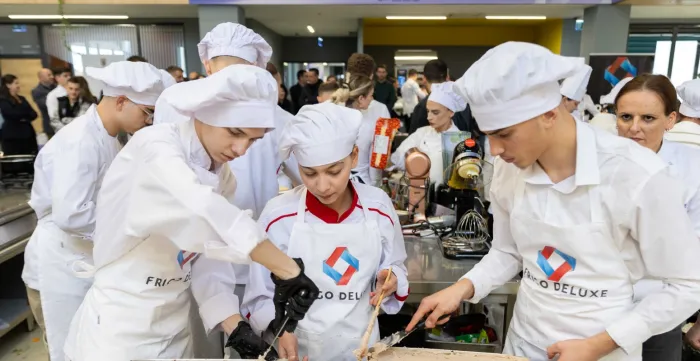 Students are preparing a dish together. 