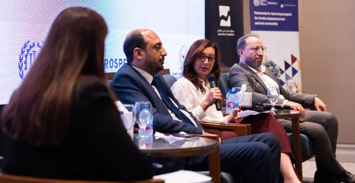 panel members at jordan event speaking from the podium