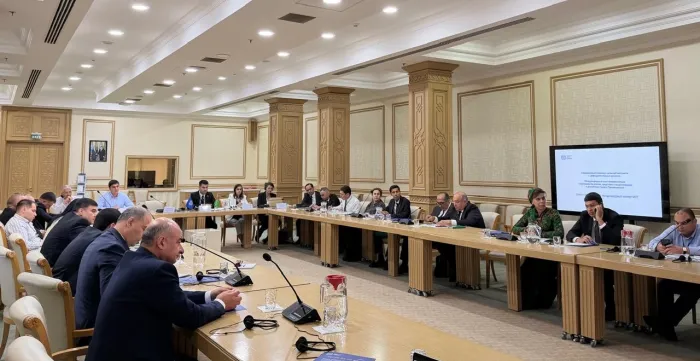 People sitting around U-shaped conference table