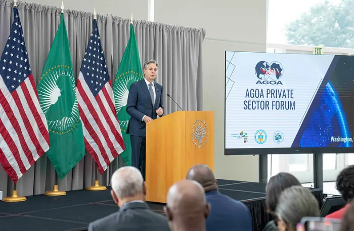 white man standing in podium delivering a speech