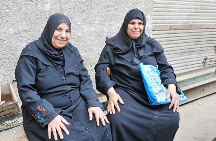 Two women sit outside in Bab el Foutouh District. Cairo, Egypt.