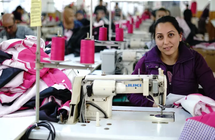 Syrian refugee learning skills in the garment sector