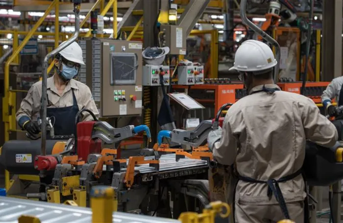 Workers working in the Thai automotive plant.