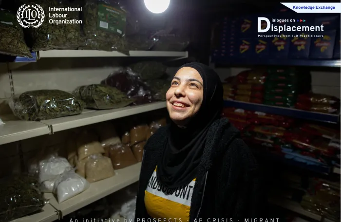 woman standing inside her grocery shop looking at the bulb