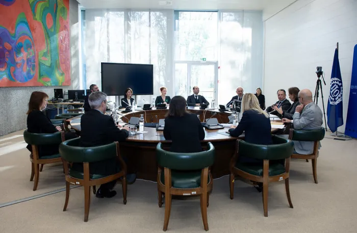 high level managers from ILO and Eni at a round table in the ILO premises