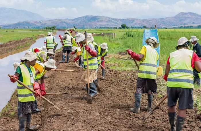 Workers on an ILO project rebuild a drain in Ambondromisotra, Madagascar