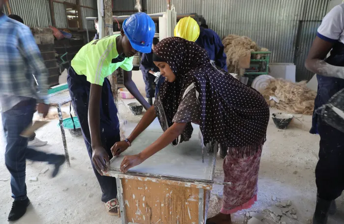 a young woman and a man attending training on woodwork in Ethiopia.