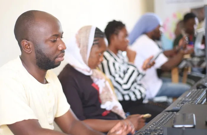 Five participants of a training workshop working on computers