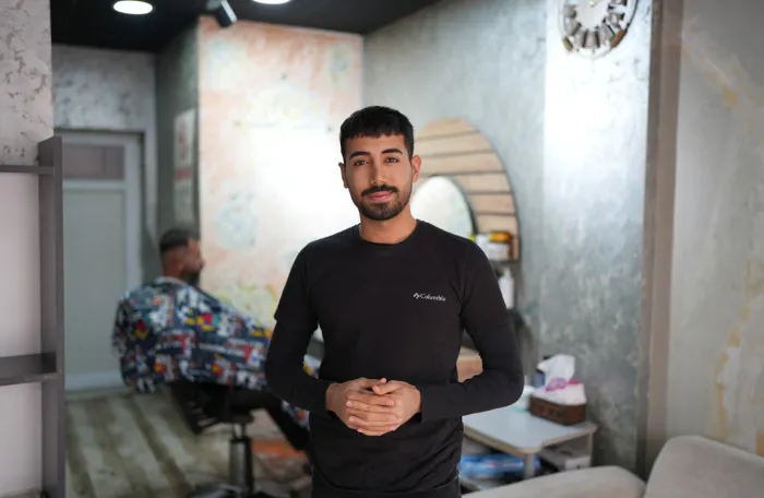 22-year-old man called Halid Fahil in his hair cut shop