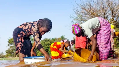 Women do gold mining in an informal mine