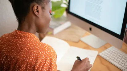 woman writing in notebook