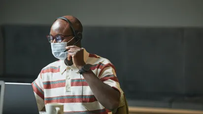 man in a mask working