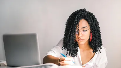 woman writing in notebook