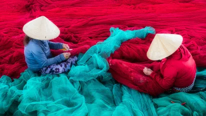 Two women sorting fishing nets in Viet Nam