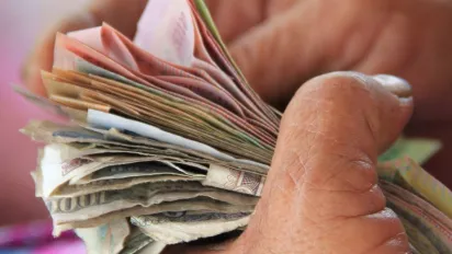 Image of a hand holding money