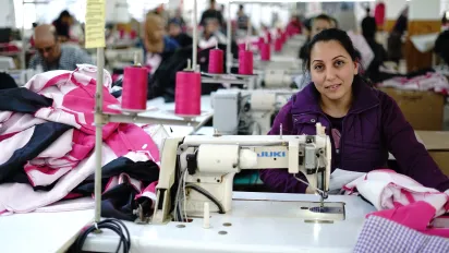 Syrian refugee learning skills in the garment sector