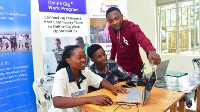 Three trainees working on their laptops