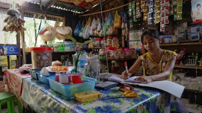 Saleswoman in a little shop in Myanmar