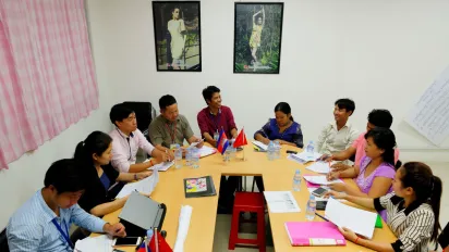 Women and men having discussion in a u-shape seating.