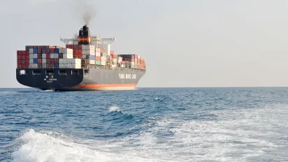 A view of the Chinese ship the "Y M Orchid" leaving the harbour. Port of Genoa, Italy